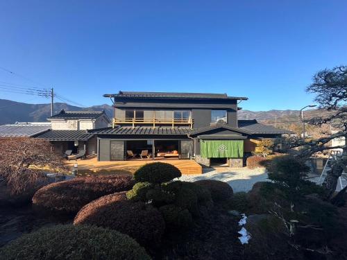 a large house with a roof at KURA YARD in Fujikawaguchiko