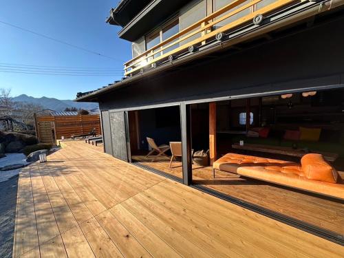 a building with a wooden deck with a view at KURA YARD in Fujikawaguchiko