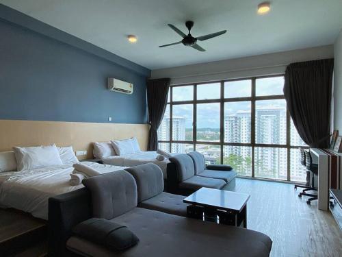 Habitación de hotel con cama, sofá y ventana grande. en 2-4 Pax Spacious Living @ Mount Austin, JB #02, en Johor Bahru