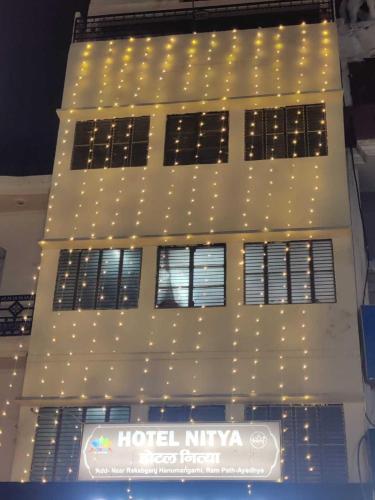 a hotel nirvana with lights on a building at Hotel O Nitya in Ayodhya
