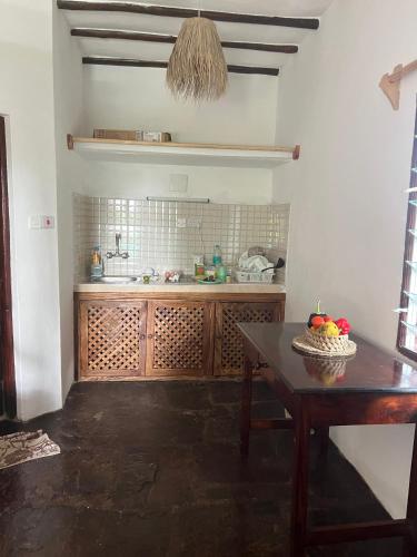 a kitchen with a table and a counter top at BeB Sardegna2 Anjumasa village in Watamu