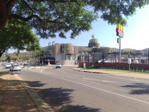 a street with cars driving down a road at Zenith Guesthouse in Pretoria