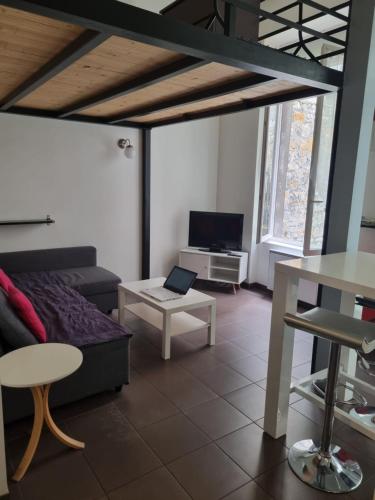 un salon avec un canapé et une table dans l'établissement Cité du Desgn avec mezzanine et cour, à Saint-Étienne