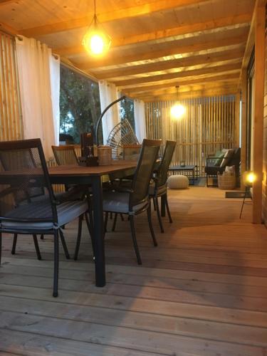 a wooden table and chairs on a porch at mobile home MIRNA in Biograd na Moru