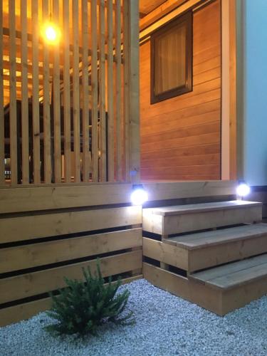 a wooden wall with two steps and lights on it at mobile home MIRNA in Biograd na Moru