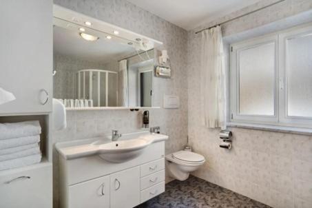 a bathroom with a sink and a toilet and a mirror at Gasthof Innerwalten in San Leonardo in Passiria