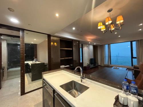 a kitchen with a sink and a large window at Guangzhou City Inn Hotel Apartment Pazhou in Guangzhou
