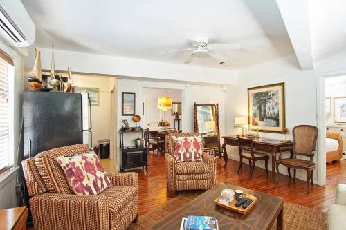 a living room with chairs and a dining room at Burns Square Boutique Hotel in Sarasota