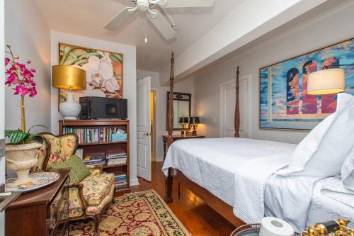 a bedroom with a large bed and a chair at Burns Square Boutique Hotel in Sarasota