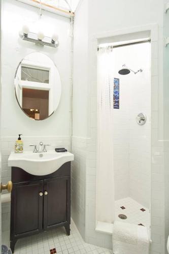 a bathroom with a sink and a shower with a mirror at Burns Square Boutique Hotel in Sarasota