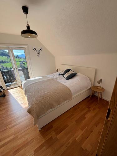 a bedroom with a bed and a large window at Haus St Peter in Radenthein
