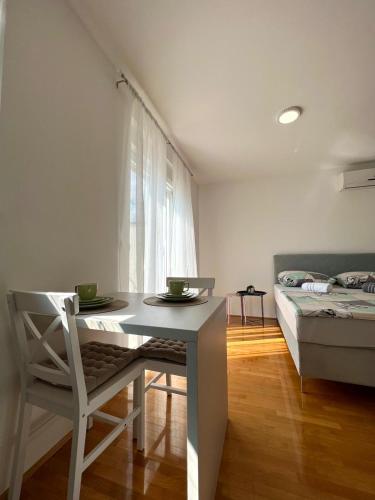 a room with a table with a chair and a bed at Mostar in Mostar