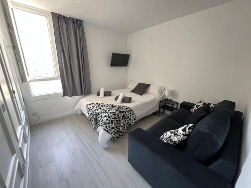 a living room with a bed and a couch at Playamar Feliz in Torremolinos
