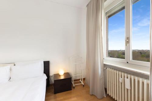 a bedroom with a bed and a large window at Allianz House - Panoramic San Siro cozy house in Milan