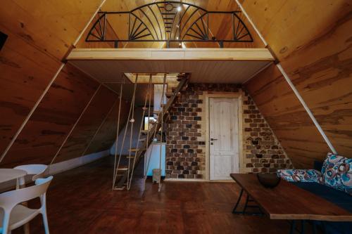 a room with a loft with a ladder and a staircase at BlackWood A frame in Nurrnus