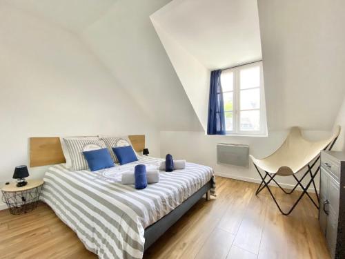 a bedroom with a large bed with blue pillows at LE CACTUS - Beau T2 - 10 min du centre à pied et parking facile in Quimper