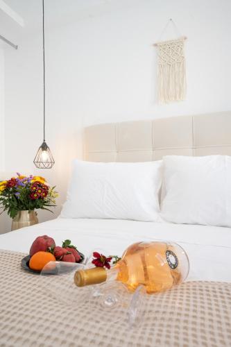a tray of fruits and vegetables on a bed at Myconian Little Venice Elite Suites with Sea View in Mýkonos City