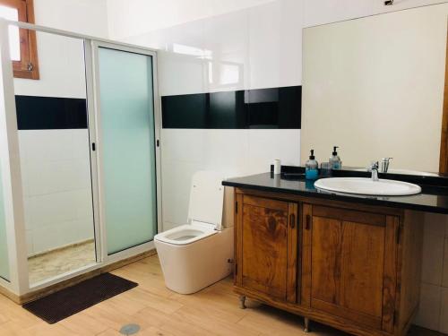 a bathroom with a sink and a toilet at Get house kira in Cidade Velha