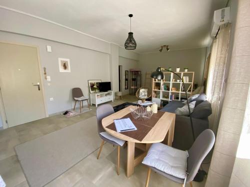 a living room with a table and a couch at Xrysa's Central City Apartment in Mesolongion