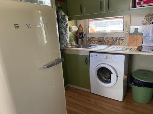 a small kitchen with a washing machine and a sink at Casa di Babbo …la Cabane in Sorbo-Ocagnano