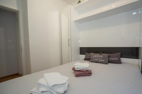 a bedroom with a bed with towels on it at Adriatic Escape Novalja-Zrce! in Novalja