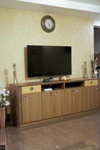 a large entertainment center with a flat screen tv at Reunion Ocean Bliss in Udupi