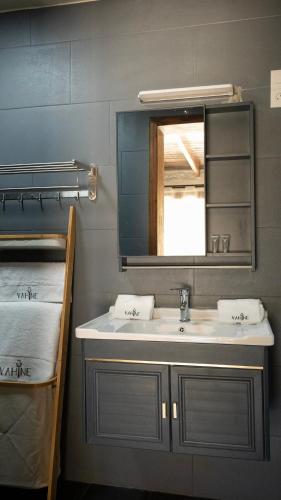 a bathroom with a sink and a mirror at LE VAHINÉ Eco-RESORT in Toliara