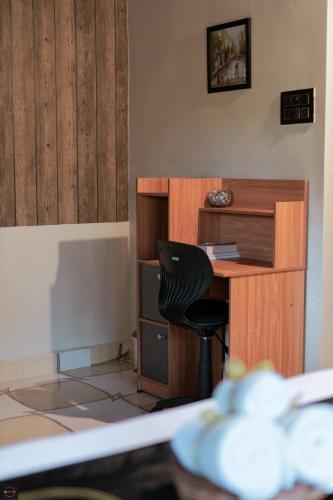 a desk and a chair in a room at Reunion Ocean Bliss in Udupi