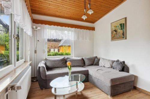 a living room with a couch and a table at Ferienhaus mit naturnahen Badeteich in Nordhausen