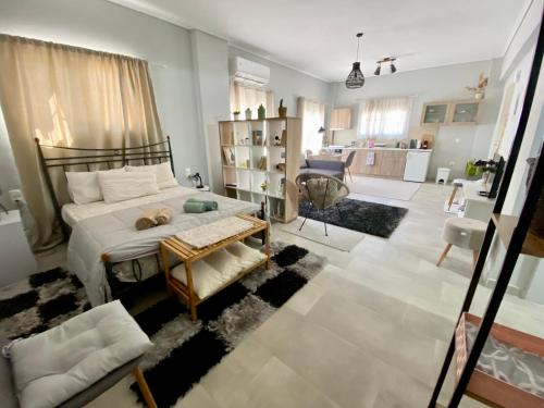 a bedroom with a bed and a living room at Xrysa's Central City Apartment in Mesolongion