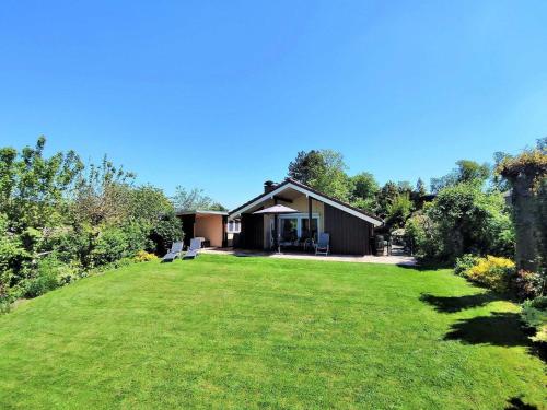 a house on a hill with a large yard at Freistehendes Ferienhaus in Rott mit eigenem Garten, schöner Weitblick, Klimaanlage, Sauna und Kamin in Extertal