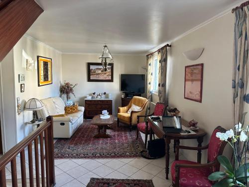 a living room with a couch and a tv at Villa martin in Antony