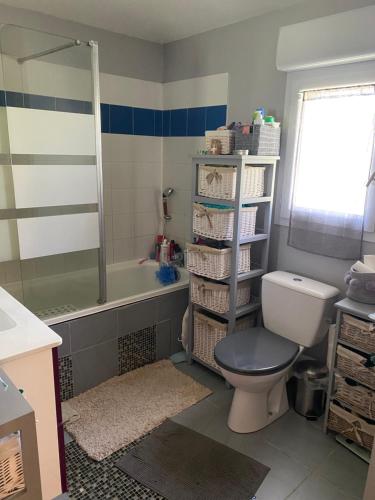 La salle de bains est pourvue de toilettes, d'un lavabo et d'une baignoire. dans l'établissement Maison au calme, à Avignon