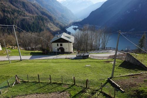 a house in a field with a view of a lake at Civetta panoramic mountain home in Alleghe