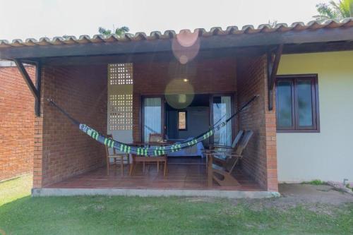 a patio of a house with a table and chairs at Hotel Praia dos Carneiros in Tamandaré