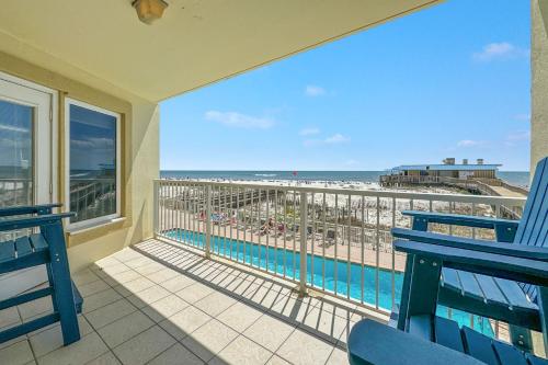 a balcony with two blue benches and a view of the beach at Boardwalk 187 in Gulf Shores