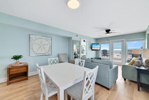 a living room with a table and a couch at Boardwalk 187 in Gulf Shores