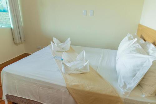 two white pillows on top of a white bed at Hotel Praia dos Carneiros in Tamandaré