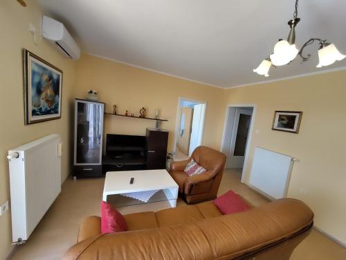 a living room with a couch and a table at Va Zamete in Rijeka