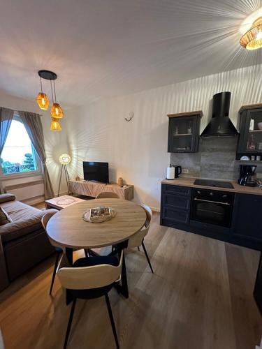 a kitchen and living room with a table and a couch at Villa Nada in Lovran