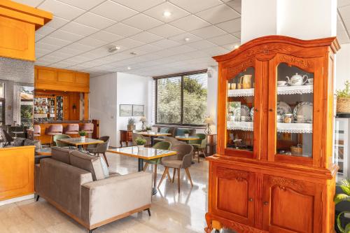 a dining room with a large wooden cabinet at Stephanos Hotel Apartments in Polis Chrysochous