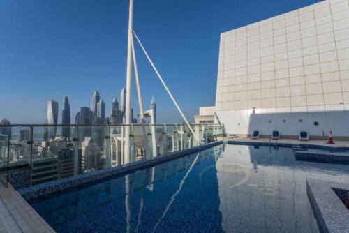 a pool on top of a building with a city skyline at Click Stay - JLT - Entire Studio & Balcony Lakes view Apartment -NA in Dubai