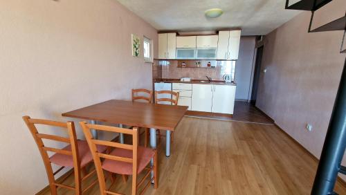 a kitchen and dining room with a table and chairs at Vila Lena in Petrovac na Moru