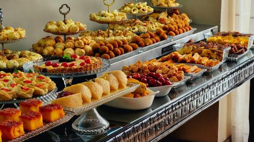 a buffet filled with lots of different types of pastries at Seringal Hotel in Manaus