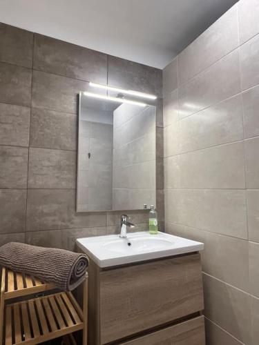 une salle de bain avec un lavabo et un miroir dans l'établissement appartement. 2 à 4 pers. lit Queen-size. Au calme., à Valréas