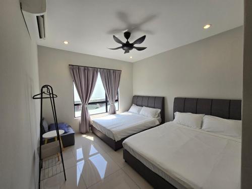 sypialnia z 2 łóżkami i wentylatorem sufitowym w obiekcie Manhattan Condominium - Jalan Pasir Puteh - Ipoh w mieście Kampong Pinji