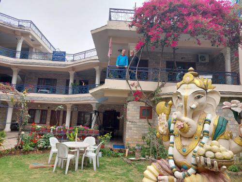 a woman standing on the balcony of a house at Blue Planet Lodge & Restaurant in Pokhara