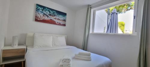 a white bedroom with a bed and a window at Relax and Explore Lisbon Suites and Rooms in Lisbon
