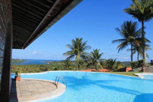 a swimming pool with a view of the ocean at Hotel Praia dos Carneiros in Tamandaré