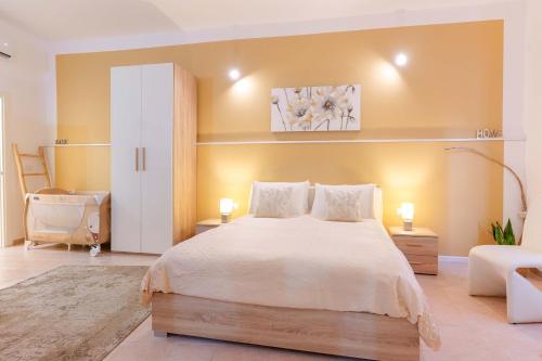 a bedroom with a large bed and a couch at Montellino's Suite Oro in SantʼAntìoco